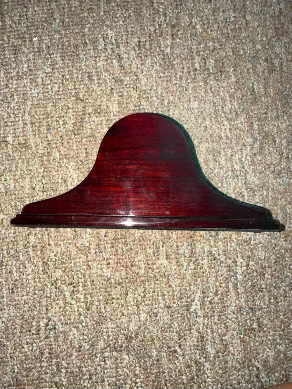 empty, polished wooden mantel clock case with a traditional arched profile